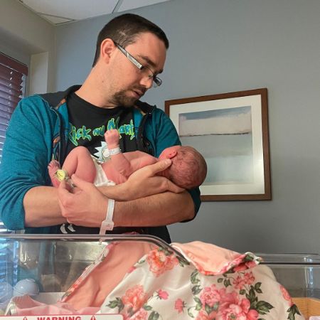 Dakota Brinkman was photographed as he held a baby in his arms.